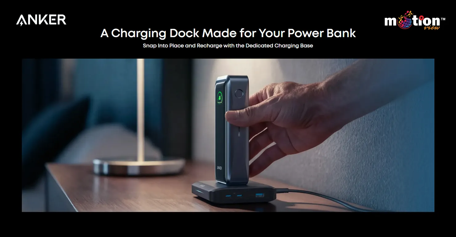 A hand snapping the Anker Prime 26K Power Bank onto its dedicated charging dock on a nightstand