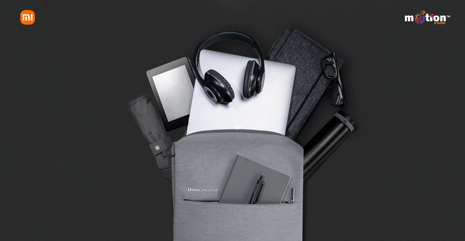 A grey Xiaomi City Backpack 2 packed with daily essentials like a laptop, umbrella, and thermos to illustrate its capacity.