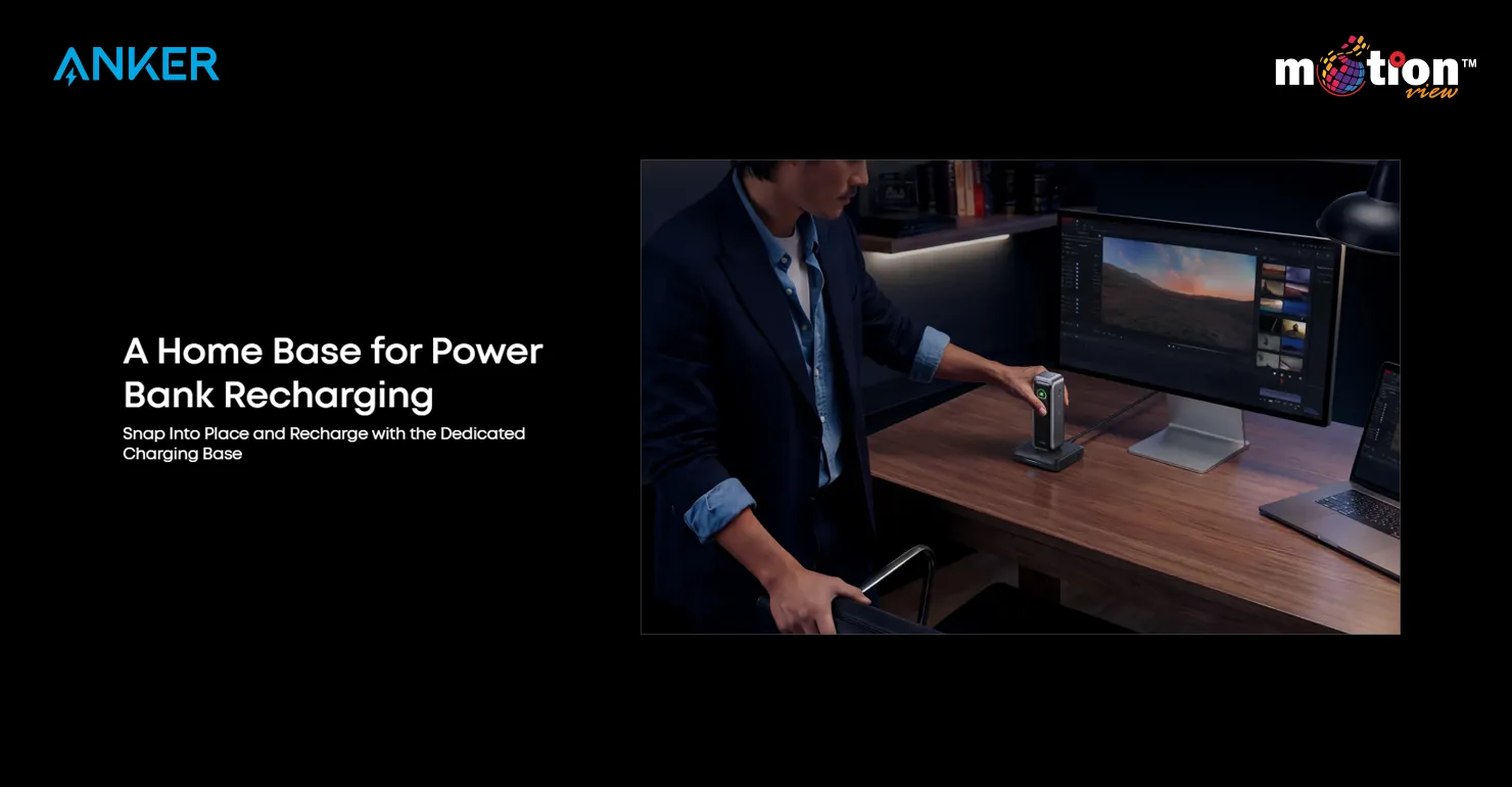A professional seamlessly snapping the Anker Prime 20K Power Bank onto its charging dock on a home office desk next to a monitor
